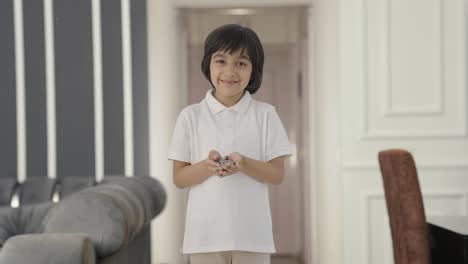 Happy-Indian-boy-holding-lot-of-coins-in-hand