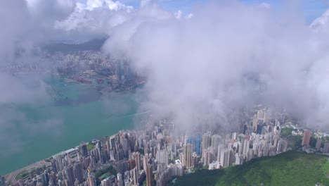 epic aerial view of the victoria harbour in a clear day, with thick cloud and sunlight