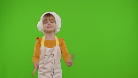 Girl-kid-dressed-as-cook-chef-baker-posing,-smiling,-looking-at-camera-on-chroma-key-background