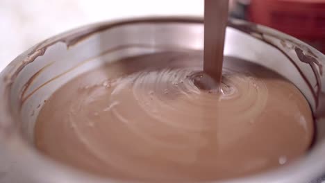 melted liquid chocolate pouring into bowl