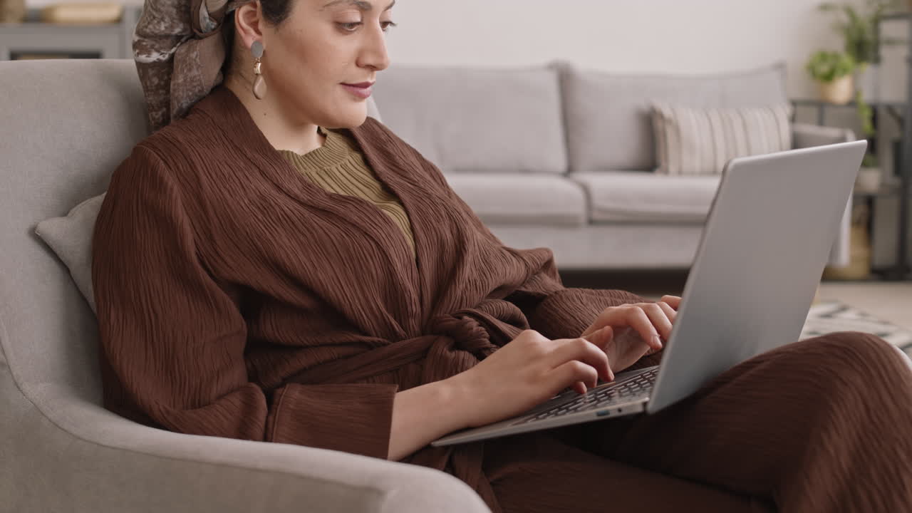 Muslim Woman with Laptop at Home