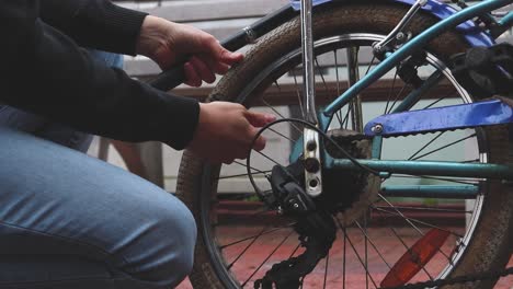 man inflating the flat tire of the bicycle