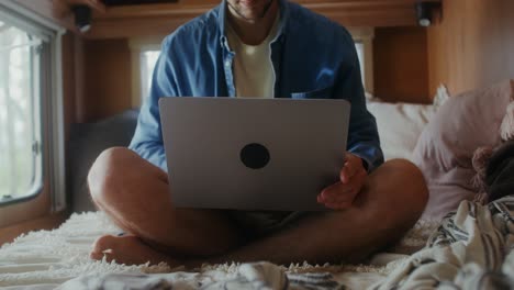 man working on laptop in rv