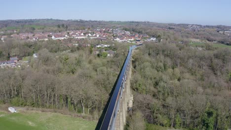 People-walk-across-the-beautiful-Narrow-Boat-canal-route-called-the-Pontcysyllte-Aqueduct-famously-designed-by-Thomas-Telford,-located-in-the-beautiful-Welsh-countryside,-A-huge-bridge-viaduct