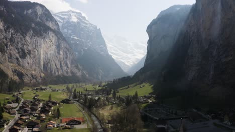 aerial ascending backwards and shows lauterbrunnen town, switzerland