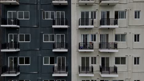 rising shot of apartments on half black and white high rise building