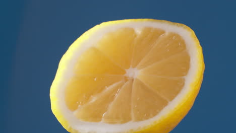 Slow-Motion-Macro-Shot-of-Flowing-Water-from-Lemon-Slice-on-white-Background