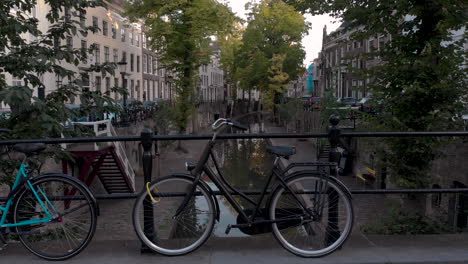 aerial early morning canal view of the nieuwe gracht in medieval dutch city of utrecht with bikes locked in on the bridge in the foreground