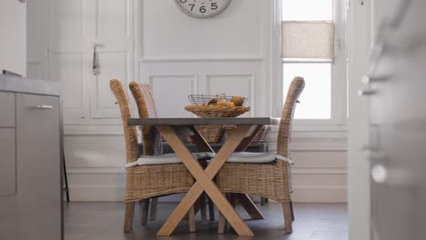 slow establishing shot of a wicker table and chair set with fresh fruit on display