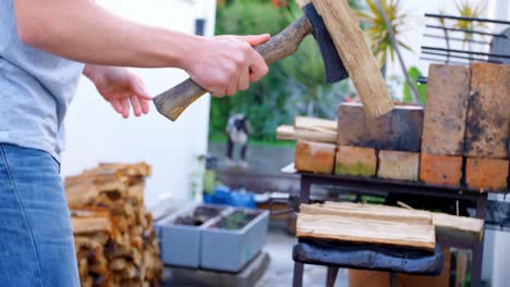 male lumberjack chopping wooden logs with axe 4k