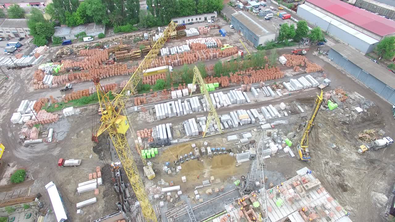 Tower Crane Build Large Residential Building. Aerial shot of the new home under construction with only the lower level built