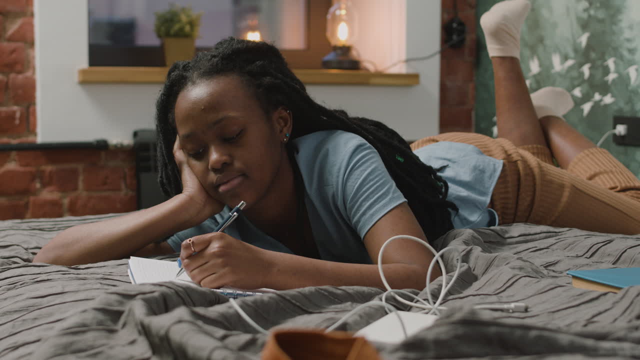 Girl Are Taking Notes Lying On The Bed In Bedroom 1