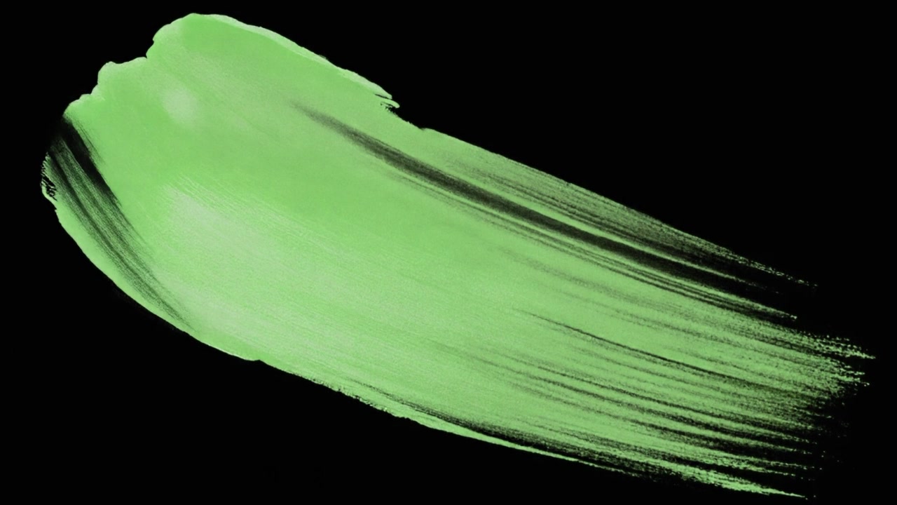 Pennellata di pittura verde su sfondo nero