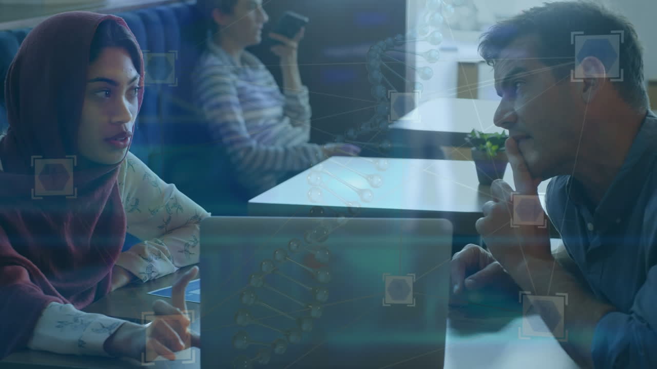 Animation of scientific data over diverse female and male coworkers using laptop