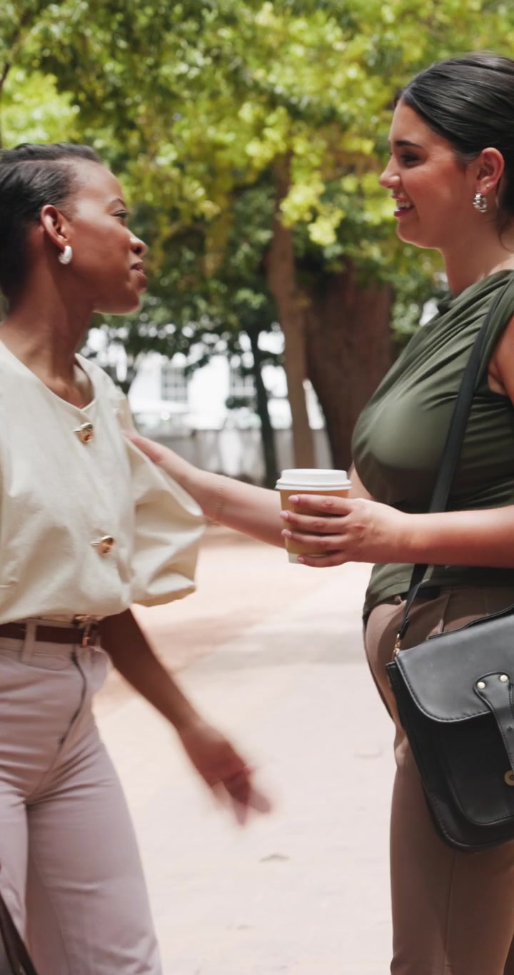 Two Women Greeting Each Other and Parting Ways in a Park