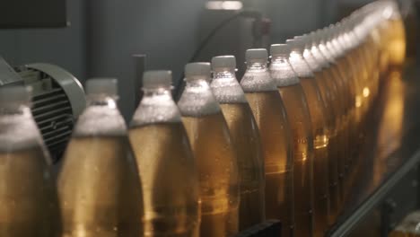 conveyor belt with bottles for juice or water at a modern beverage plant. modern production of sweet soda water