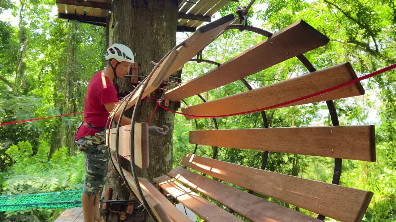 Person working on a treetop adventure park platform