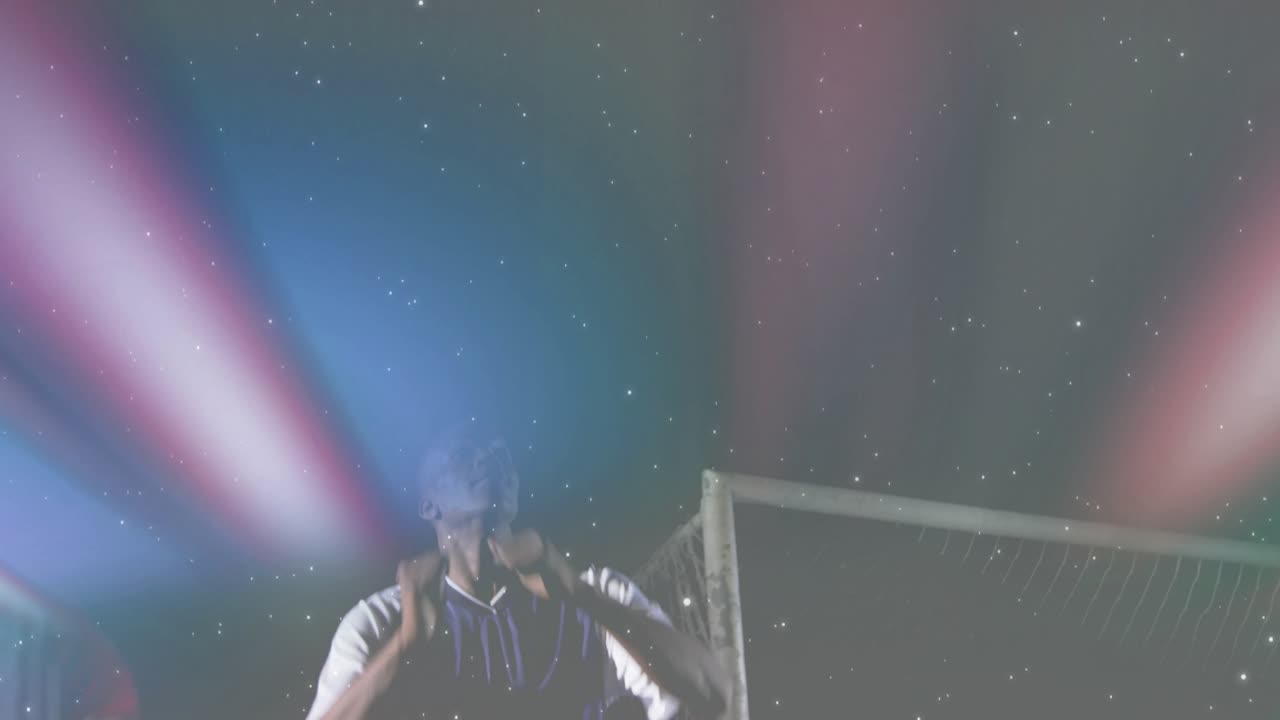 Sports promo featuring colored beams sweeping athlete lifting arms conducting sparkles around goal