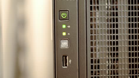 a green network indicator light blinks sporadically on a black tower server