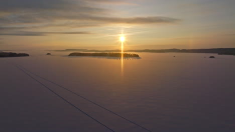 aerial view rising over lake pielinen, winter sunrise in north karelia, finland
