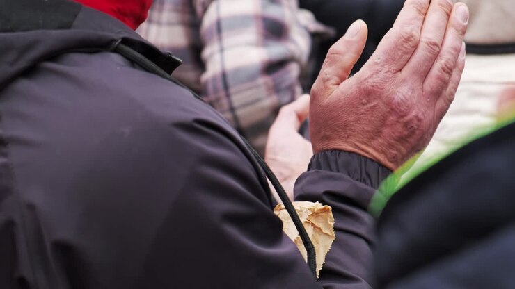 Clapping man at the protest with a lot of people
