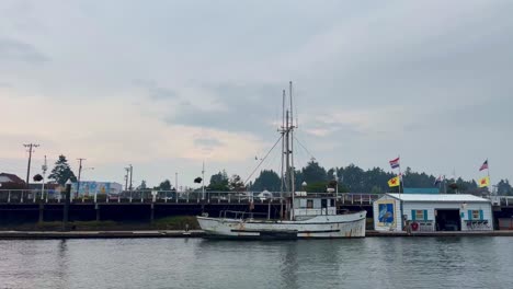 Fishing-Vessel-Moored-In-The-Harbour-At-Dusk-in-Florence,-Oregon
