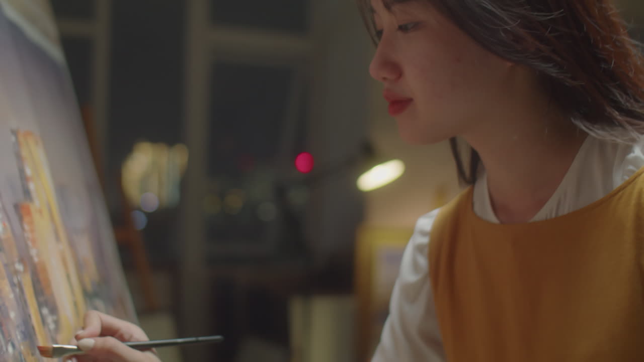 Asian Female Painter Drawing Picture on Canvas