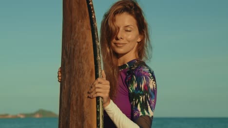 woman with surfboard at the beach