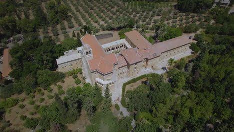 The-old-architecture-in-the-building-of-the-Silent-Monks-Monastery---the-monks-cultivating-and-selling-grape-juice,-wine,-olives-and-olive-oil-from-their-lands---parallax-shot