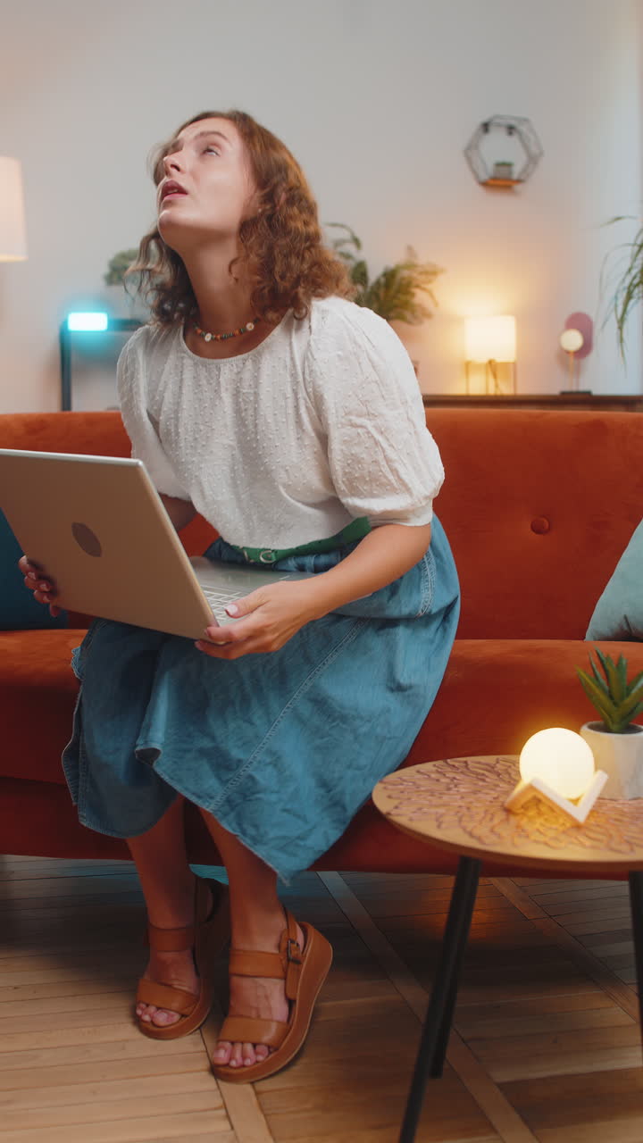 Tired young woman using laptop suffering from headache problem tension and migraine stress at home