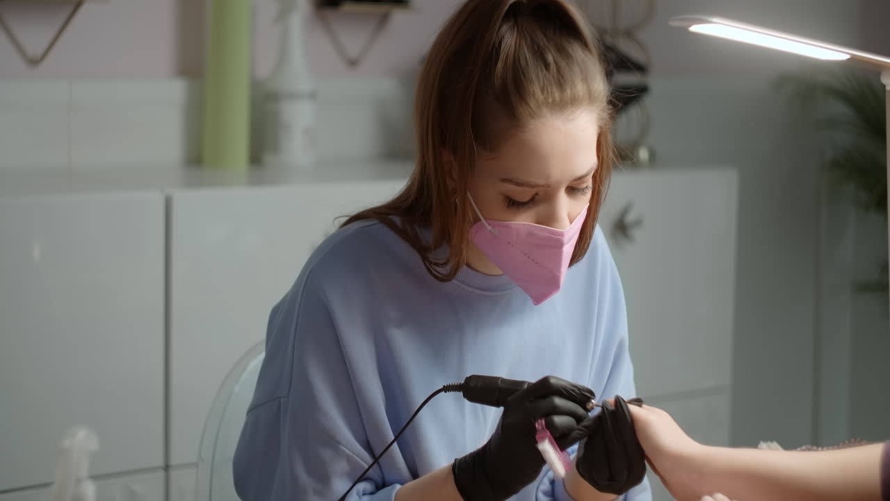 Woman getting her nails done at a nail salon