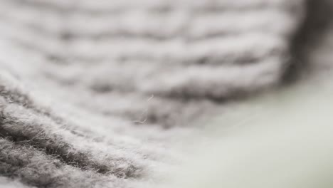 Micro-video-of-close-up-of-grey-wooly-fabric-with-copy-space