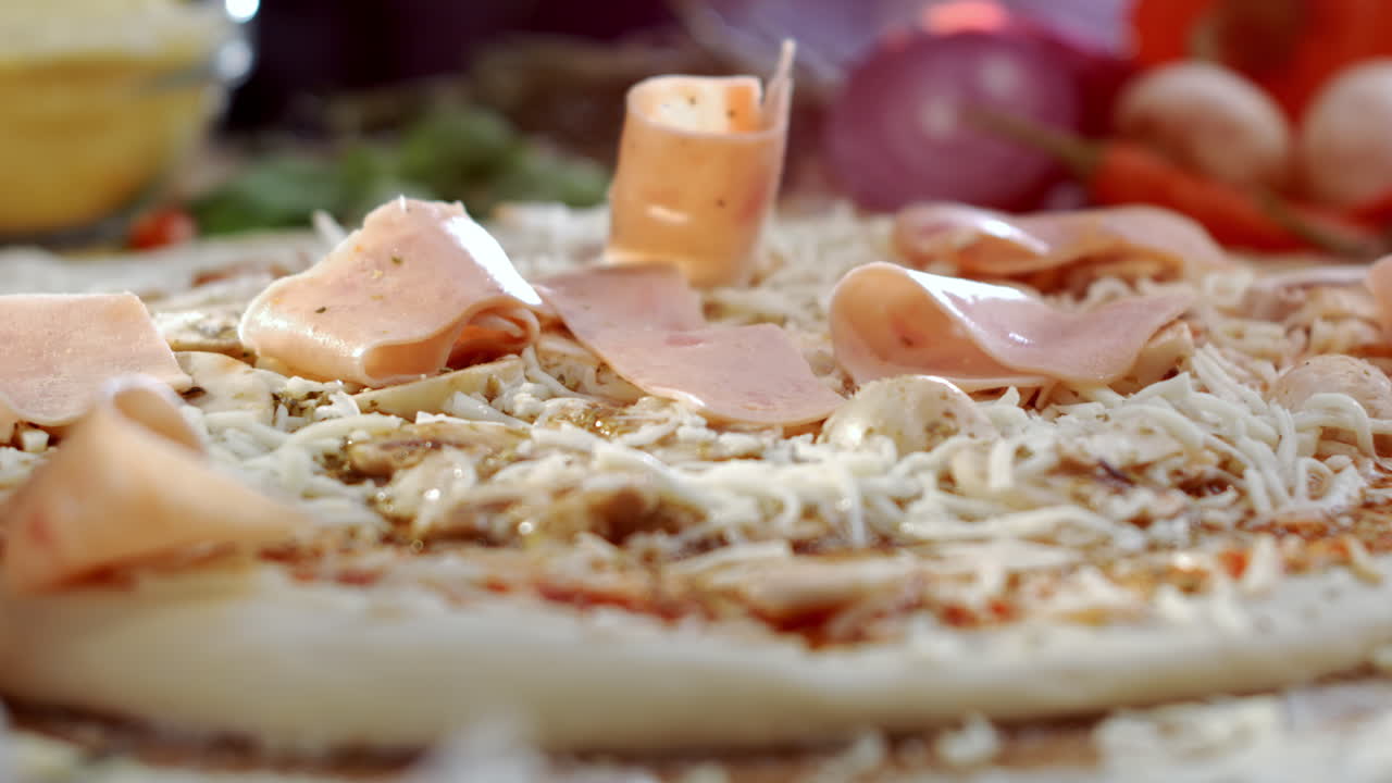 Making pizza with ham and cheese