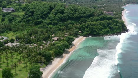 pristine white sand beach with turquoise ocean at kerandangan in senggigi lombok on sunny day, aerial