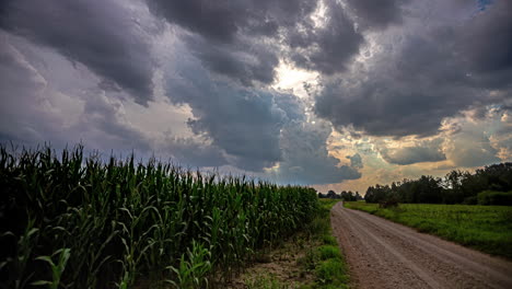 vibrant storm clouds flowing above corn field, time lapse view