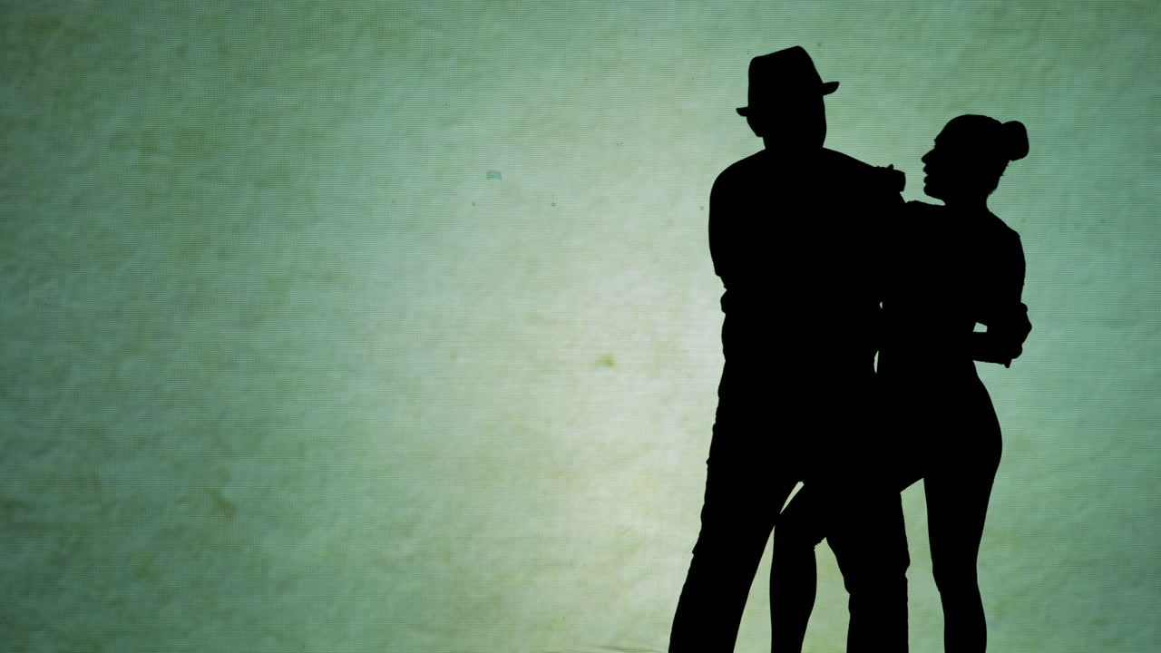 Silhouettes of a couple performing
