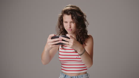 Animated-young-caucasian-lady-playing-games-on-smartphone,-medium-shot