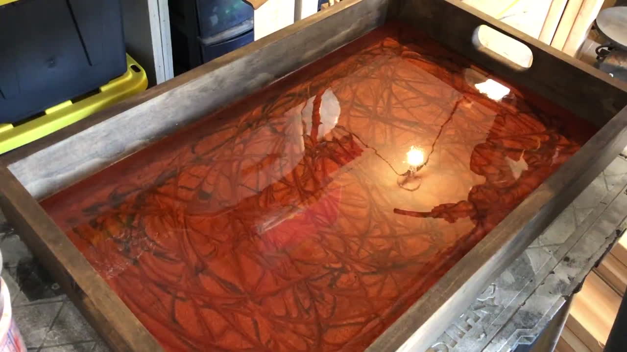 Removing bubbles from a resin mold using a handheld torch