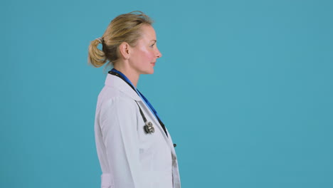 Motion-Graphics-Around-Female-Doctor-Wearing-White-Coat-Standing-In-Front-Of-Blue-Studio-Background