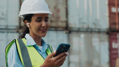 female engineer using smartphone at port