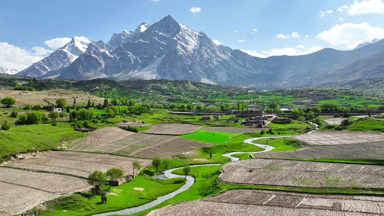 Aerial pull back shot capturing picturesque beauty of snow covered mountains in Bilamik valley at Skardu, Pakistan.