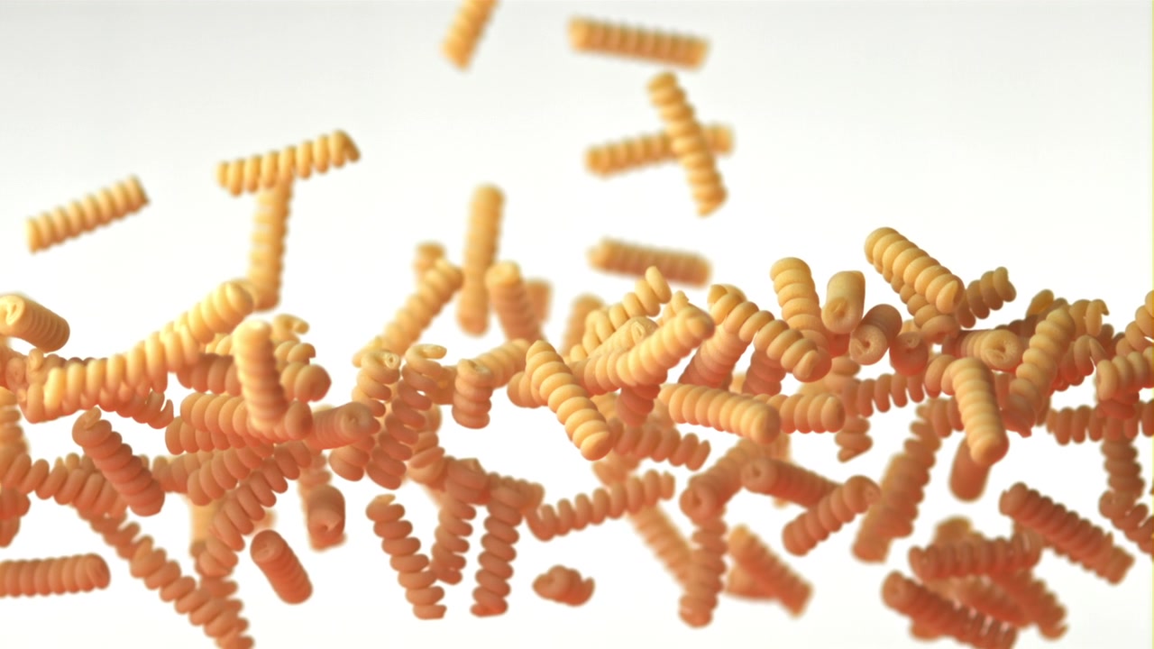 Uncooked Fusilli Pasta Falling on a White Background