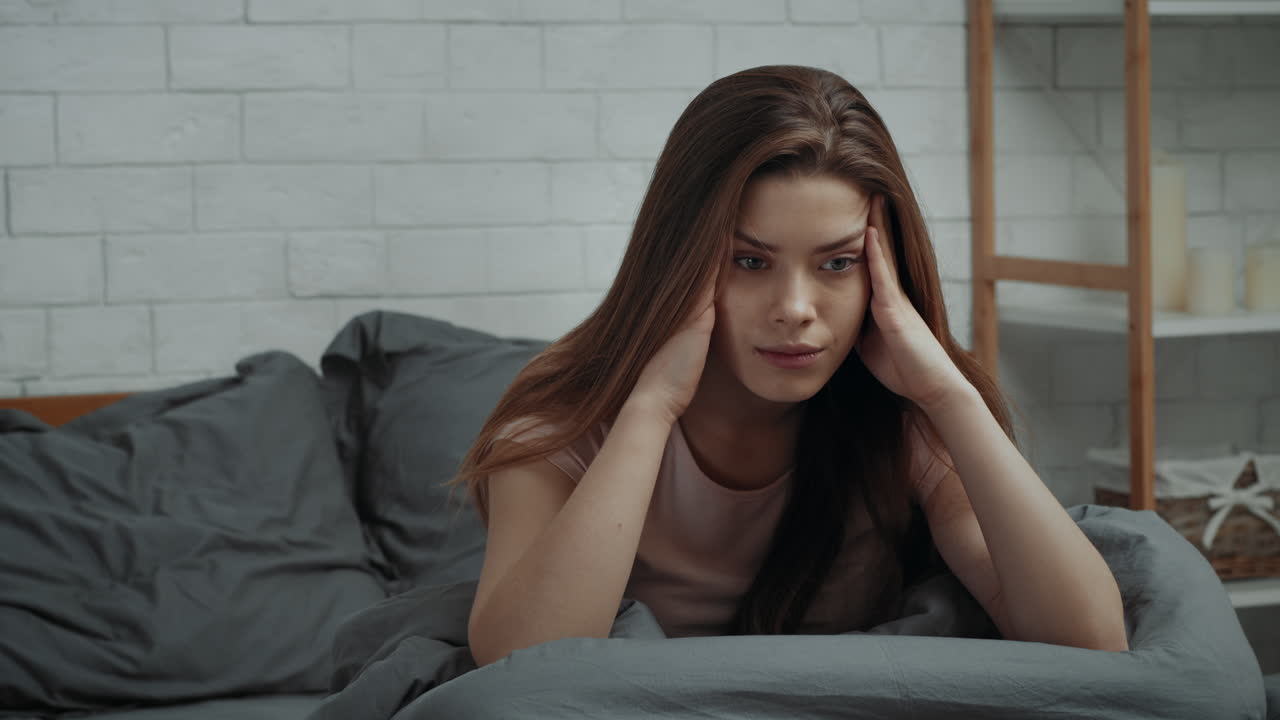 Woman in bed with a headache