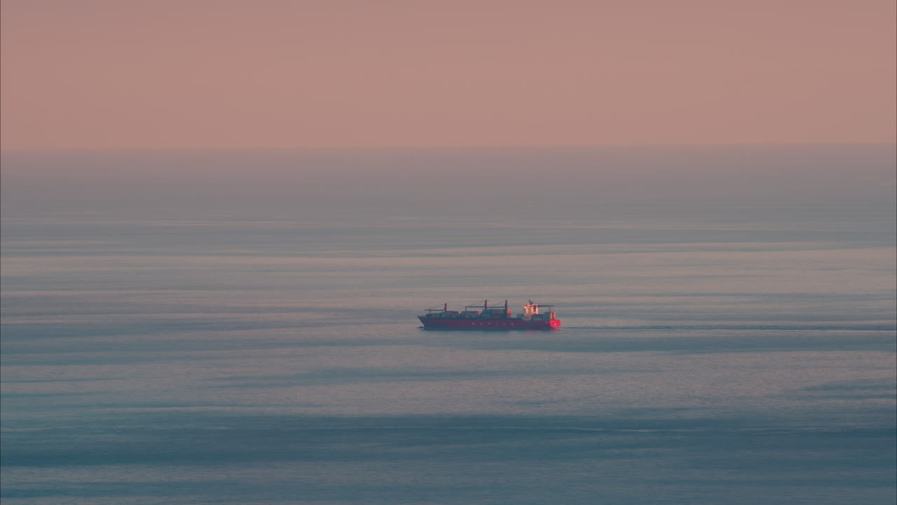 Distant view of a ship moving on the sea in the south of France at sunset