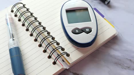 blood glucose meter on a notebook