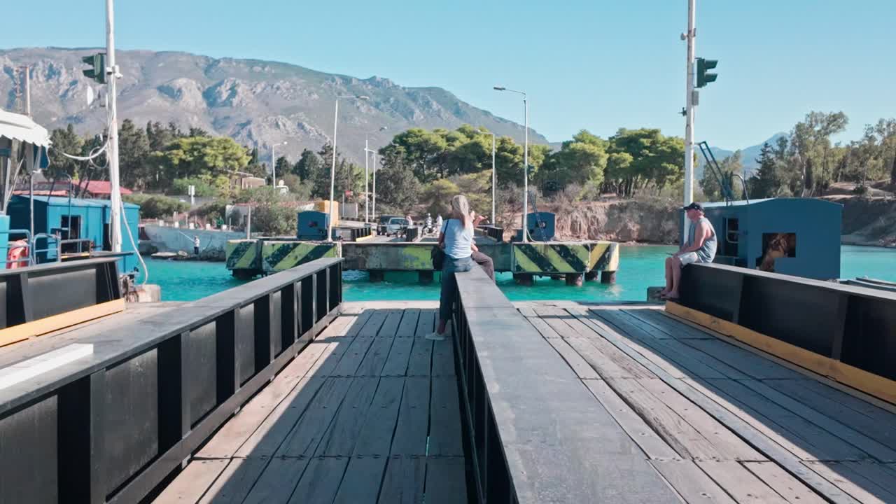 People wait to cross Corinth canal submersible road bridge
