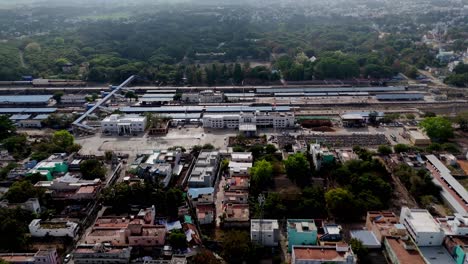rail lines with colorful trains and station sheds under bright daylight