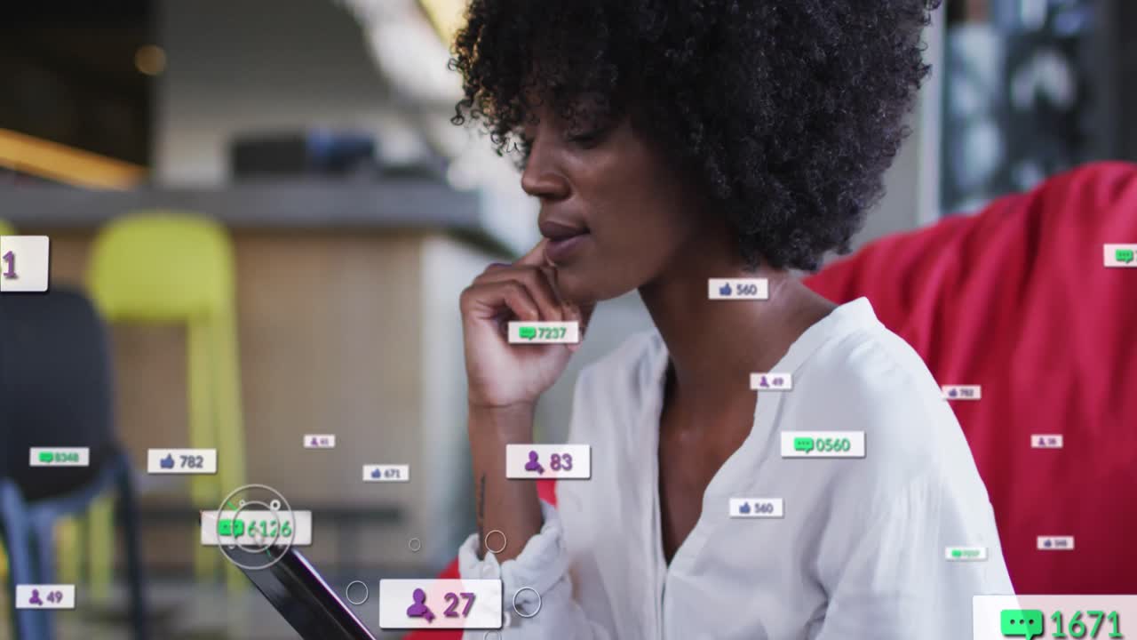 Animation of social media icons over african american businesswoman