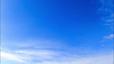 beautiful blue sky with almost no clouds. white altocumulus cloudscape appear and cover the sky. low angle view.