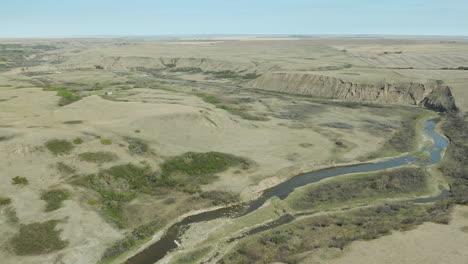 flowing stream on hillside at river breaks in saskatchewan, canada